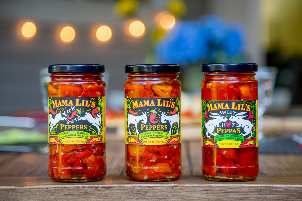 Three jars of Mama Lil's Peppers on the background of a blurred kitchen