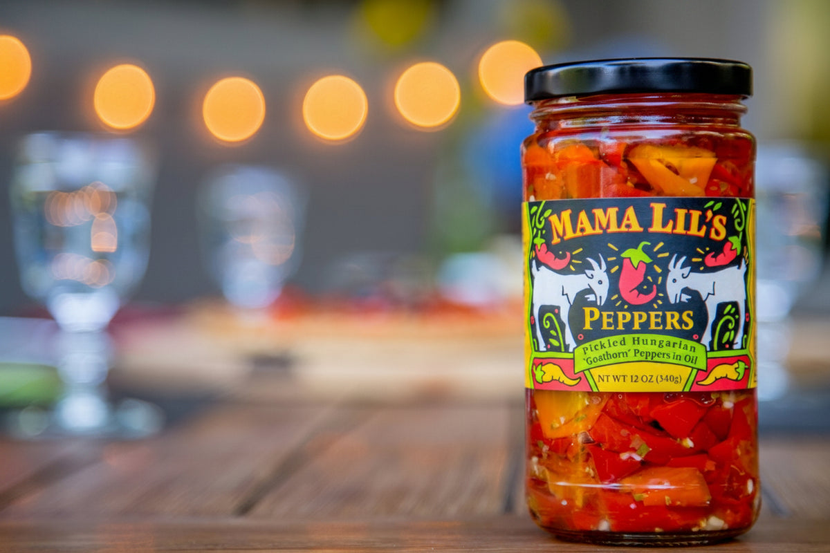 A jar of Mama Lil's peppers on the background of a blurred kitchen!