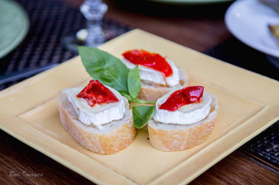 Mama Lil's pepper rings and goat cheese on slices of french bread